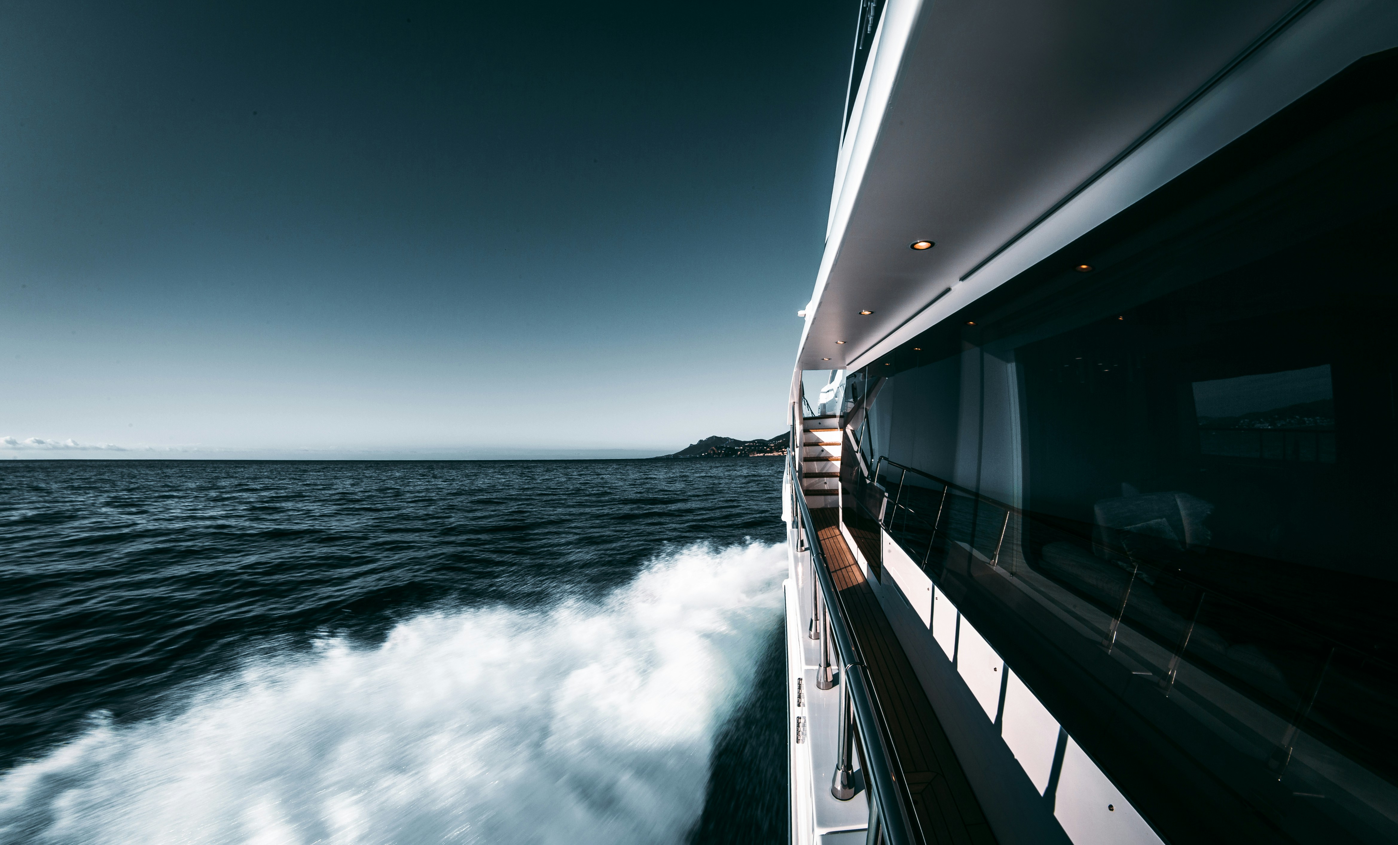 View along a motor yacht as it cruises across open water